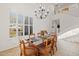 Spacious dining room with a chandelier and large windows at 40208 N Faith Ln, Anthem, AZ 85086