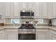 Stainless steel gas cooktop and microwave in a well-lit kitchen at 4127 W Granite Basin Dr, New River, AZ 85087