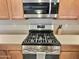 Stainless steel gas range and microwave in a modern kitchen setting at 42127 N Celebration Way, Anthem, AZ 85086