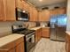 Modern kitchen featuring stainless steel appliances and light wood cabinets at 42127 N Celebration Way, Anthem, AZ 85086