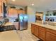 Open kitchen with island and stainless steel appliances at 42127 N Celebration Way, Anthem, AZ 85086