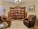 Built-in bookcase filled with books and comfortable armchairs at 42127 N Celebration Way, Anthem, AZ 85086