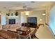 Spacious living room featuring a stone fireplace, leather furniture, and a large TV at 42127 N Celebration Way, Anthem, AZ 85086
