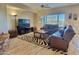 Living room with leather furniture and a fireplace at 42127 N Celebration Way, Anthem, AZ 85086