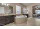 Spa-like bathroom with soaking tub, double vanity, and separate shower at 4712 S Onyx Dr, Chandler, AZ 85249