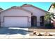 Single-story house with a two-car garage and desert landscaping at 5128 S 6Th St, Phoenix, AZ 85040