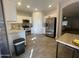 Modern kitchen with white cabinets and stainless steel appliances at 5128 S 6Th St, Phoenix, AZ 85040