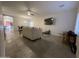 Bright living room with gray tile floors and a large TV at 5128 S 6Th St, Phoenix, AZ 85040