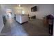 Bright living room with gray tile floors and a large TV at 5128 S 6Th St, Phoenix, AZ 85040
