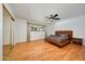 Spacious main bedroom with hardwood floors, a ceiling fan, and wood platform bed at 5301 E Emile Zola Ave, Scottsdale, AZ 85254