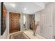 Bright entryway with dark wood door, tile flooring, and coat rack at 5663 N 73Rd St, Scottsdale, AZ 85250