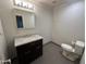 This bathroom features a new dark wood vanity with a stunning white marble countertop and gray tile flooring at 615 E Winter Dr, Phoenix, AZ 85020