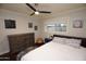 Charming bedroom with double bed, dresser, and ceiling fan at 615 E Winter Dr, Phoenix, AZ 85020
