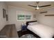 Cozy bedroom with a double bed, dresser and ceiling fan at 615 E Winter Dr, Phoenix, AZ 85020