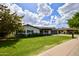 Charming single-story home with blue shutters, a green lawn, and a modern garage door at 615 E Winter Dr, Phoenix, AZ 85020