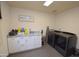 Convenient laundry room with washer, dryer, and cabinets at 615 E Winter Dr, Phoenix, AZ 85020