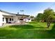 Spacious backyard patio, lush lawn, and citrus tree at 615 E Winter Dr, Phoenix, AZ 85020