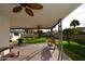 Covered patio with built-in BBQ and grassy backyard at 615 E Winter Dr, Phoenix, AZ 85020