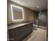 Modern bathroom featuring a vanity with a gray countertop, a sleek, lighted mirror, and glass-enclosed shower at 6587 N Palmeraie Blvd # 2022, Paradise Valley, AZ 85253