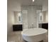 Luxurious bathroom with a standalone tub, double vanity, and modern design at 6587 N Palmeraie Blvd # 2022, Paradise Valley, AZ 85253