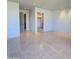 Minimalist bedroom with tile flooring, neutral walls, and doorways to a closet and bathroom at 6587 N Palmeraie Blvd # 2022, Paradise Valley, AZ 85253