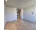 Spacious bedroom with a neutral palette, tile floors, and access to a hallway through a modern glass door at 6587 N Palmeraie Blvd # 2022, Paradise Valley, AZ 85253