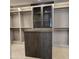 A walk-in closet is fitted with custom shelving and features a center island and additional display cabinets at 6587 N Palmeraie Blvd # 2022, Paradise Valley, AZ 85253