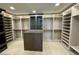 Large walk-in closet with custom shelving and island at 6587 N Palmeraie Blvd # 2022, Paradise Valley, AZ 85253