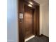 Stylish wood door entrance, providing privacy and security to the condo residence at 6587 N Palmeraie Blvd # 2022, Paradise Valley, AZ 85253