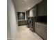Functional laundry room is equipped with modern appliances, custom cabinetry, and sleek countertops at 6587 N Palmeraie Blvd # 2022, Paradise Valley, AZ 85253