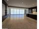 Bright living room featuring tile flooring, custom shelving, and an open floor plan at 6587 N Palmeraie Blvd # 2022, Paradise Valley, AZ 85253