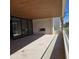 Expansive covered patio with tile flooring and a stone accent wall provides an ideal outdoor living space at 6587 N Palmeraie Blvd # 2022, Paradise Valley, AZ 85253
