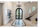 Bright entry with black iron doors and marble flooring at 6800 E Caballo Dr, Paradise Valley, AZ 85253