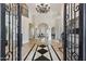 Grand entryway with black iron doors and a stunning chandelier at 6800 E Caballo Dr, Paradise Valley, AZ 85253