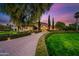 Grand estate entrance with paved driveway and lush landscaping at 6800 E Caballo Dr, Paradise Valley, AZ 85253