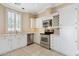 Kitchen features white cabinets, stainless steel appliances, and a wine rack at 6800 E Caballo Dr, Paradise Valley, AZ 85253