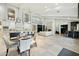Spacious open floor plan with fireplace, kitchen, dining area, high ceilings, and travertine tile flooring at 6800 E Caballo Dr, Paradise Valley, AZ 85253
