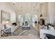 Elegant living room with fireplace, high ceilings, and ample natural light at 6800 E Caballo Dr, Paradise Valley, AZ 85253