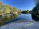 Scenic view of a tranquil lake surrounded by lush greenery under a clear blue sky at 7751 E Glenrosa Ave # A1, Scottsdale, AZ 85251