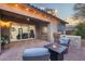 Relaxing backyard patio with fire pit and built-in grill at 8716 W Artemisa Ave, Peoria, AZ 85383