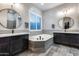 Double vanity bathroom with soaking tub and large mirrors at 8716 W Artemisa Ave, Peoria, AZ 85383