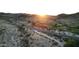 Aerial view of a road winding through desert landscape and golf course at 8829 S 51St St # 3, Phoenix, AZ 85044
