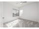 Well-lit bedroom featuring a window with blinds and carpet flooring at 8829 S 51St St # 3, Phoenix, AZ 85044