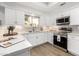 Modern white kitchen with stainless steel appliances and quartz countertops at 8829 S 51St St # 3, Phoenix, AZ 85044