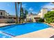 Inviting community pool with surrounding patio and trees at 8829 S 51St St # 3, Phoenix, AZ 85044