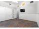 Bedroom with wall-mounted TV and tile flooring at 9654 E Pantera Ave, Mesa, AZ 85212