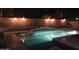 Night view of a refreshing pool with surrounding landscaping and lighting at 9654 E Pantera Ave, Mesa, AZ 85212