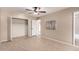 Bedroom with mirrored closet doors and ceiling fan at 10012 W Sandstone Dr, Sun City, AZ 85351