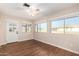 Bright bedroom with wood-look tile flooring, sliding door to patio, and ceiling fan at 10012 W Sandstone Dr, Sun City, AZ 85351