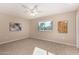 Light and airy bedroom with tile flooring and ceiling fan at 10012 W Sandstone Dr, Sun City, AZ 85351